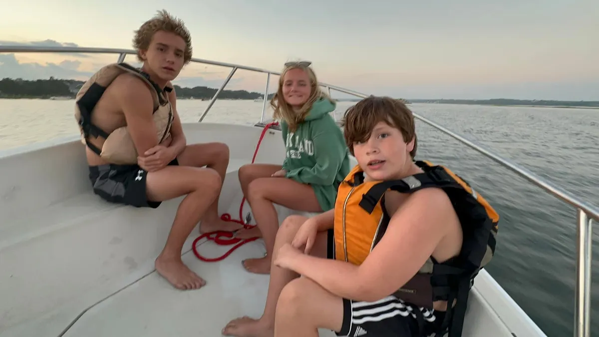 John, Perry & Patrick Long on the bow of the boat at twilight